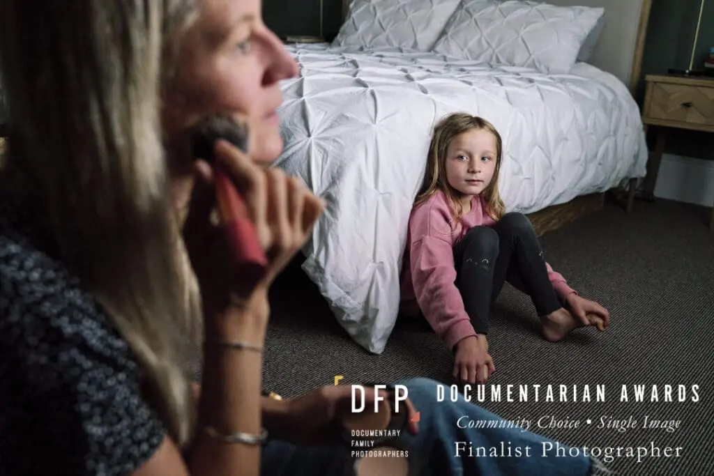Award-winning documentary family photography London by Portray Your Story showing an image of daughter looking at mum putting on her make-up. 