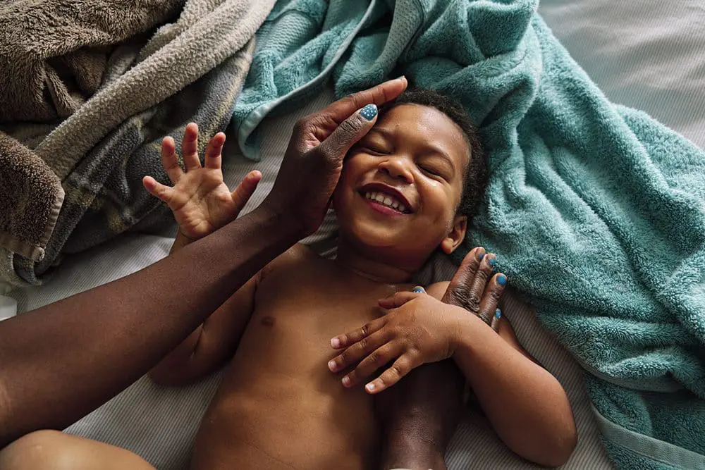 Boy smiling after bath covered in cream — candid family photography Bromley South-East London