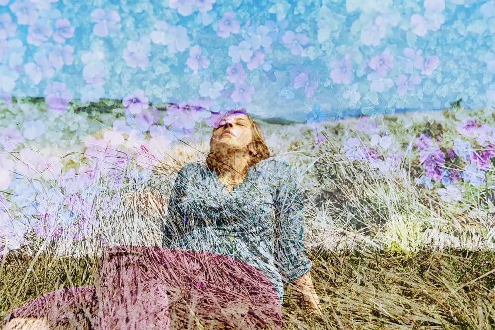 Woman lying in autumn leaves — creative personal brand photography session London