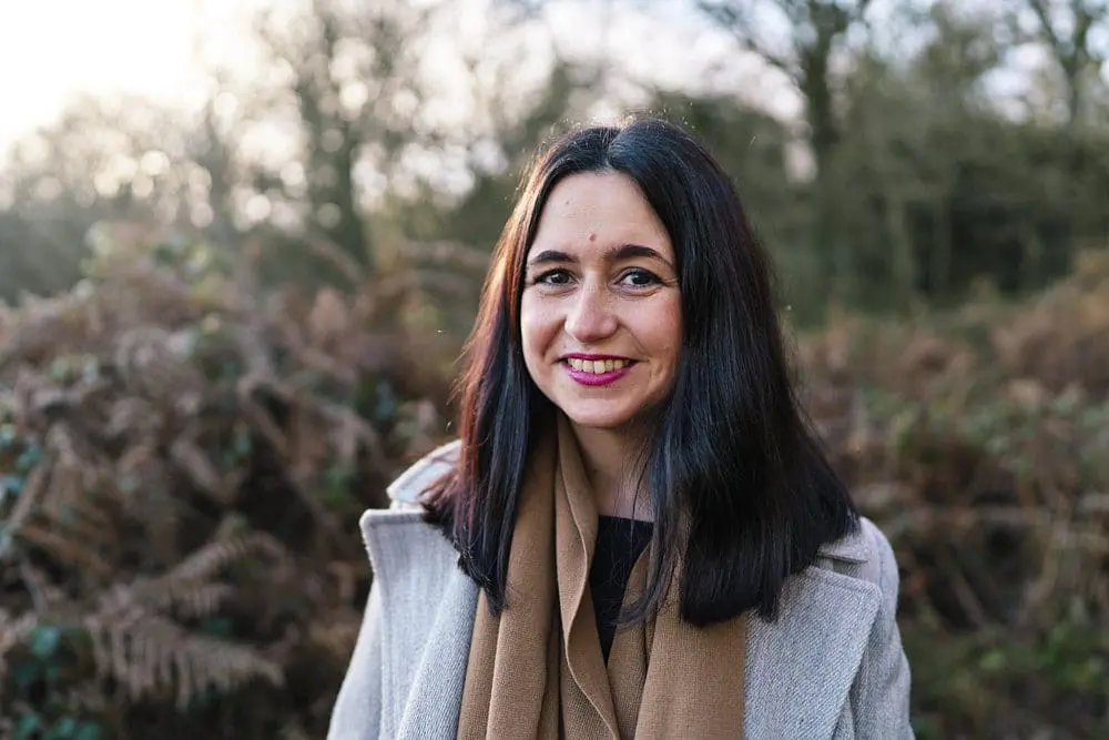 Personal brand photography headshot of woman smiling in woodland — brand photographer London