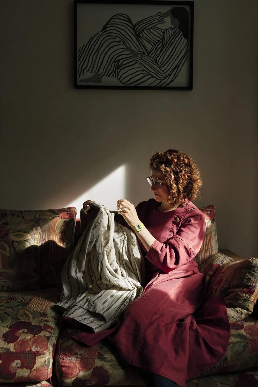 Clothing stylist surrounded by clothes on her sofa — personal brand photoshoot South-East London