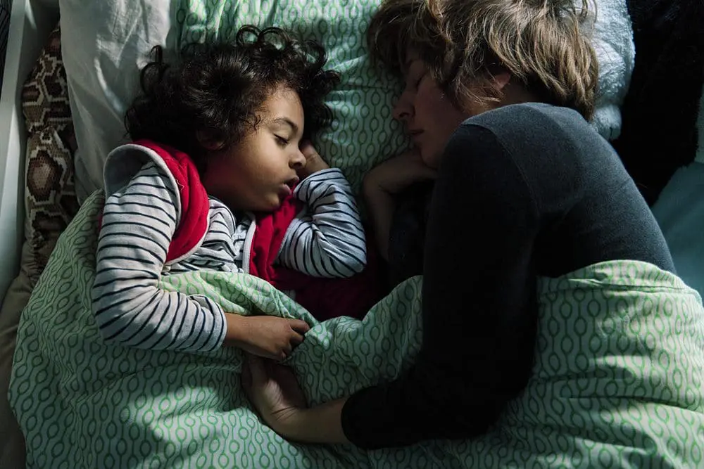 Saskia Albers documentary photographer resting with her eldest son — personal moment captured at home in South-East London