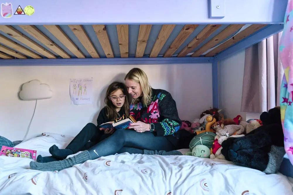 Mother and daughter reading for bedtime during a documentary family photography session.