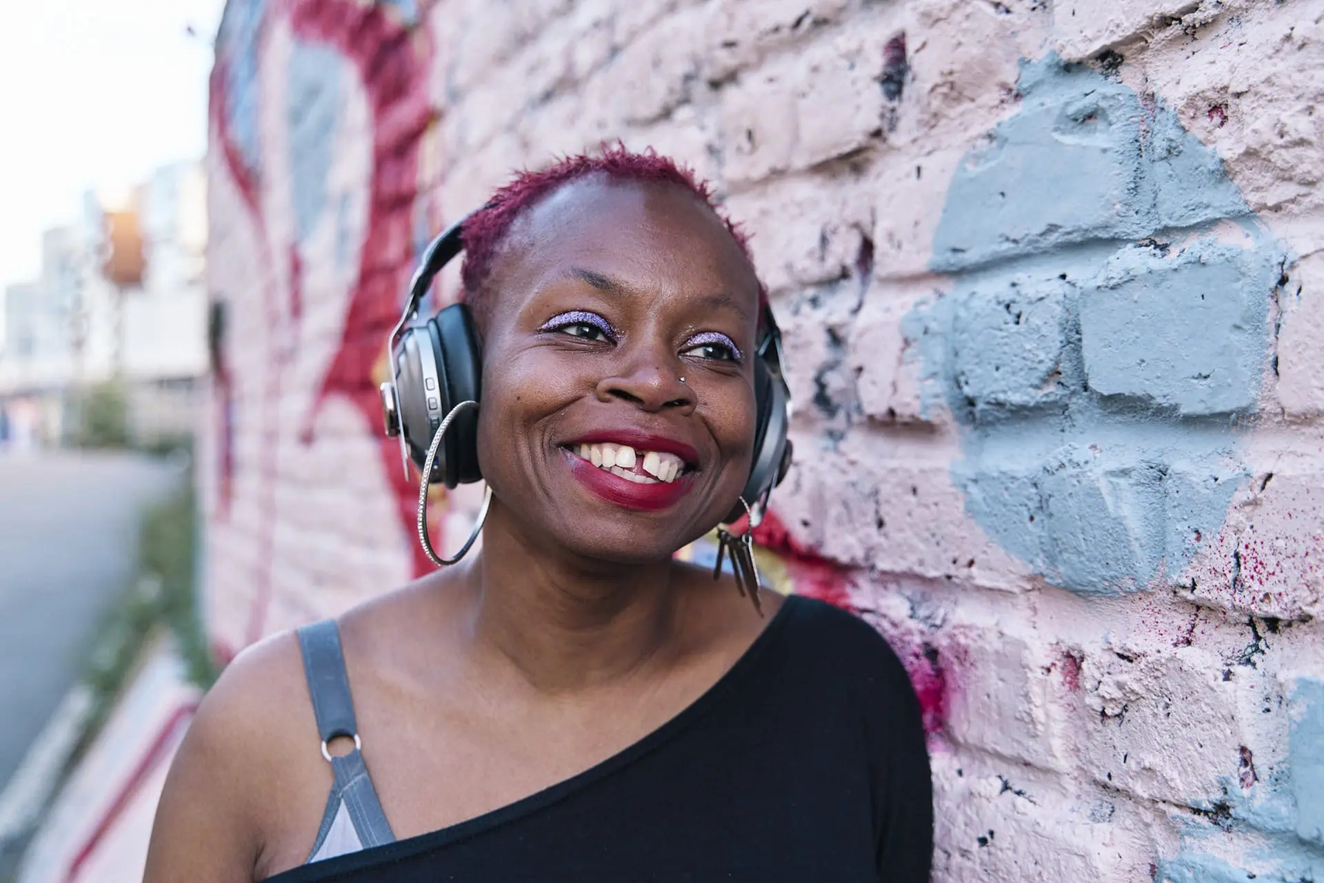 Woman smiling with headphones on — natural mini headshot session London