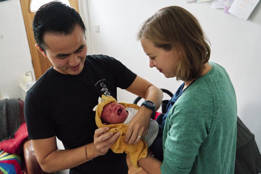 Baby crying while being dressed during a photography photoshoot in Bromley