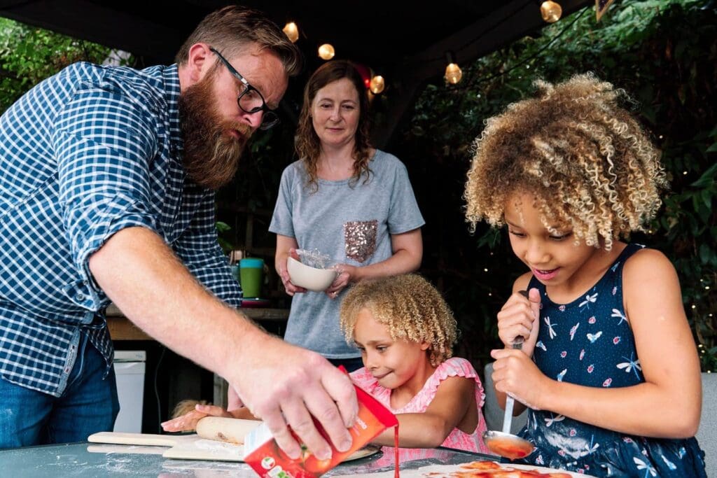 Whole family baking pizza during a family photo shoot in Hayes Bromley London
