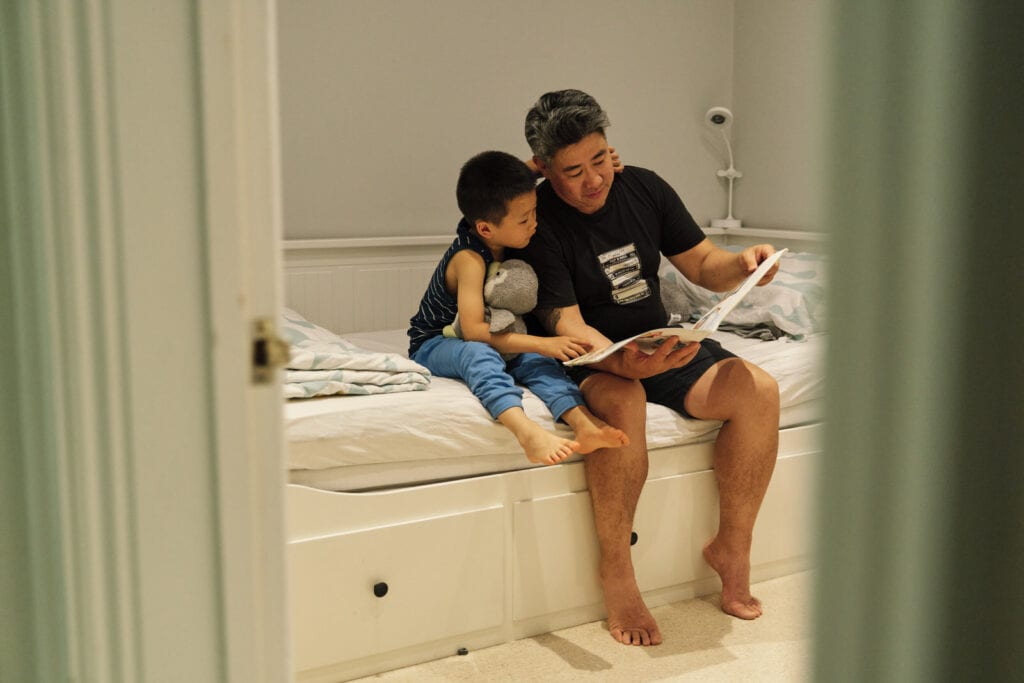 reluctant dad reads to child during family photo session