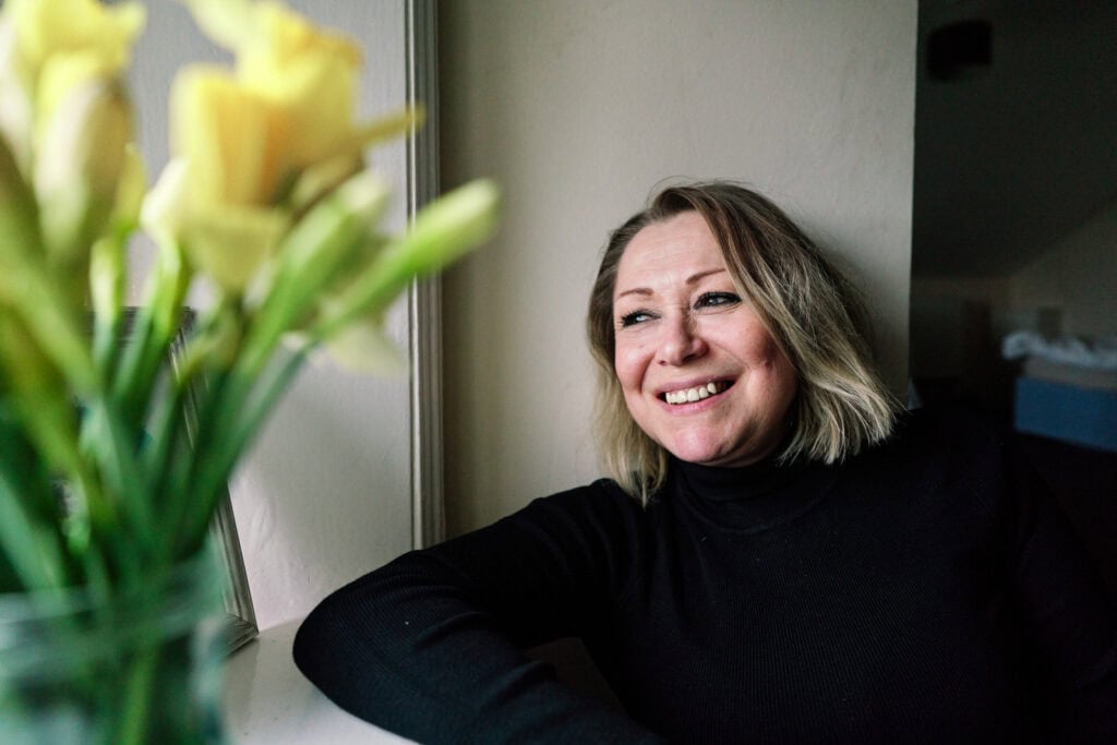 Woman feeling comfortable and happy during her storytelling charity photo session.