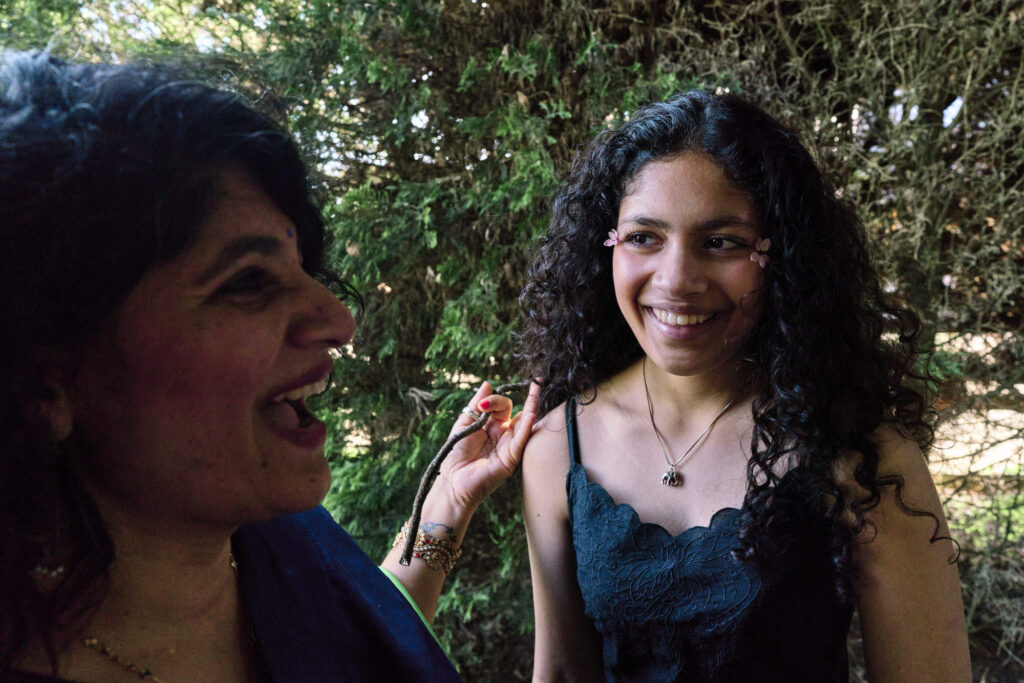 Mother and teen daughter laughing in a photo which they were happy with to share online. 