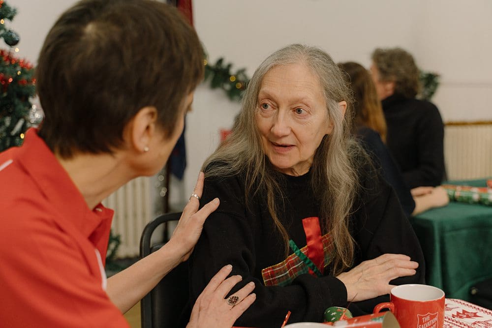 Older model for a charity campaign being supported by the charity staff.