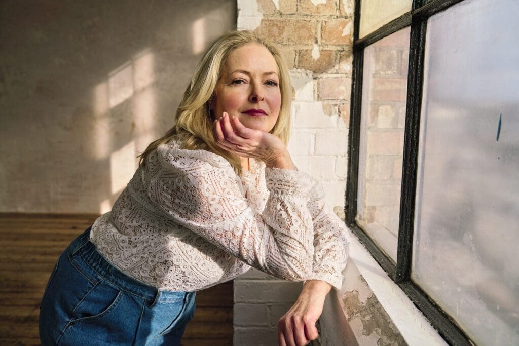 Natural branding photograph of female entrepreneur looking relaxed into the camera authentically during London personal branding photography session