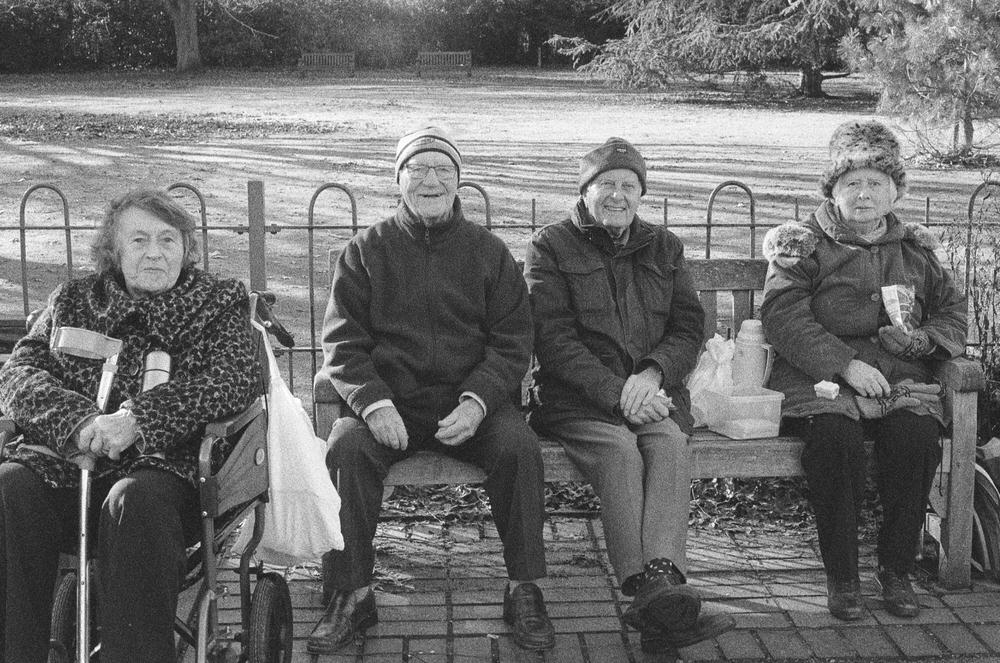 street portrait of elderly sitting ion a park bench taken during a photo walk in Bromley