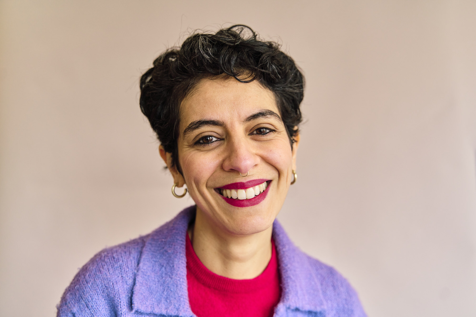 London brand photographer capturing a relaxed natural portrait of a woman entrepreneur in a softly lit indoor location