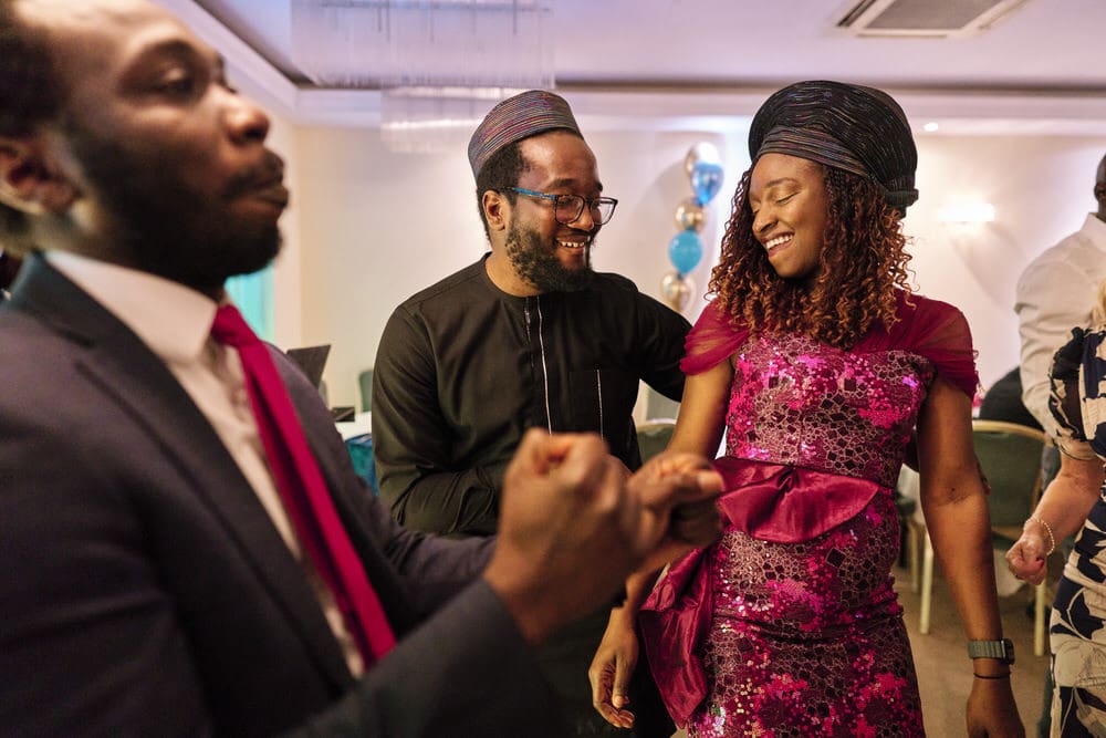 Candid documentary photography at a family gathering in London where a couple is dancing.