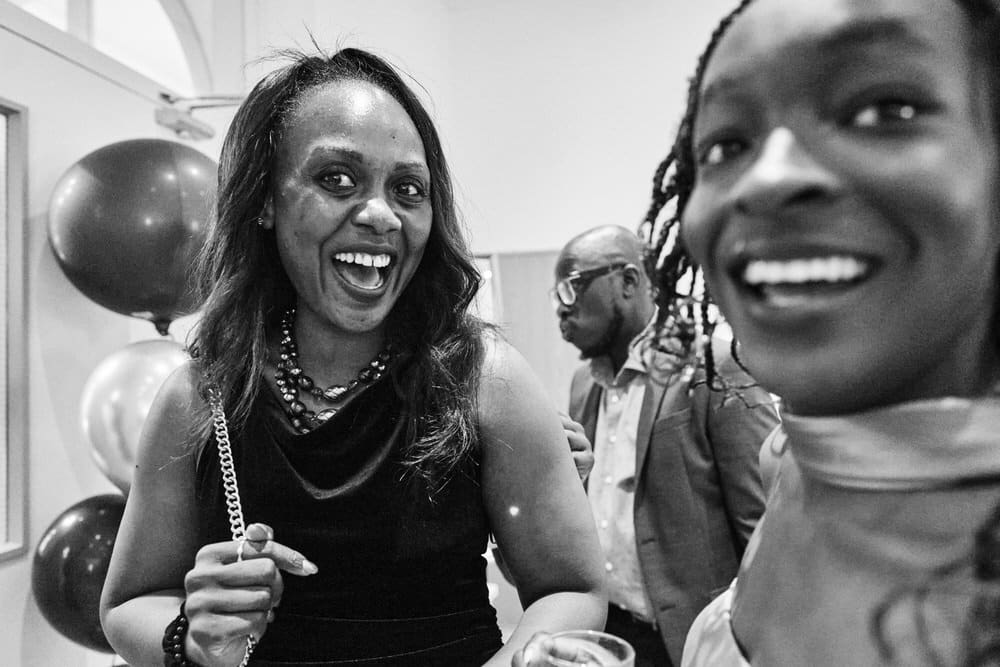 Honest family event photography in London capturing real smiling faces at a family celebration
