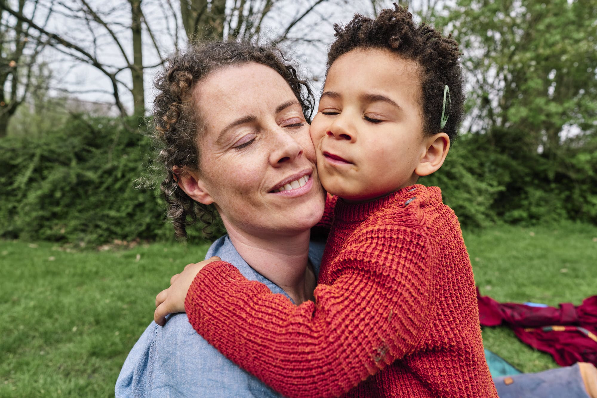 Mother and son cheek to cheek cuddling — candid documentary family photography Dulwich